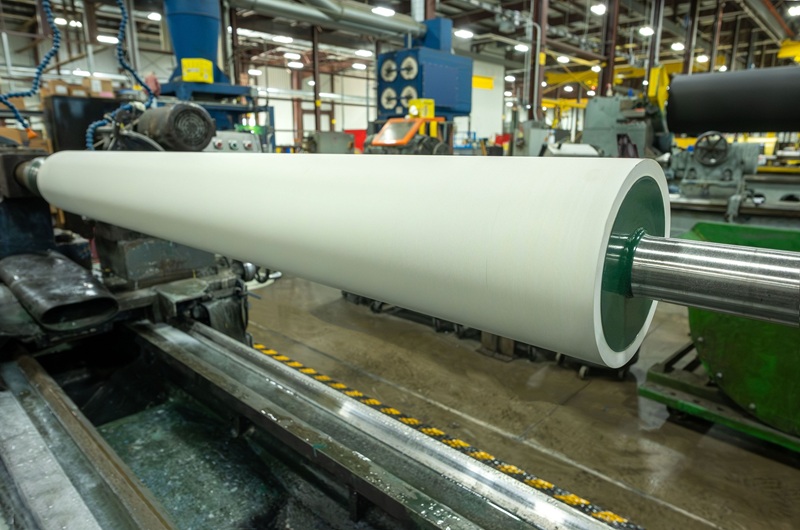 White rubber roll on lathe in production
